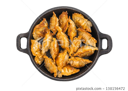 Crispy dim sum gyoza with sesame on dark plate against bright background. Asian fried dumplings ideal for culinary blogs and restaurant promotions. Crispy dim sum gyoza with sesame on dark plate against bright background. Asian fried dumplings ideal for culinary blogs and restaurant promotions. 138156472