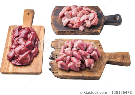 Raw poultry organs chicken hearts, liver, and gizzards on rustic wood boards, high protein ingredients for traditional cooking. 138156478