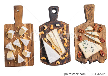 Selection of creamy Camembert soft Brie and bold Roquefort arranged with cashews pine nuts and pecans over wooden boards. Selection of creamy Camembert soft Brie and bold Roquefort arranged with cashews pine nuts and pecans over wooden boards. 138156504