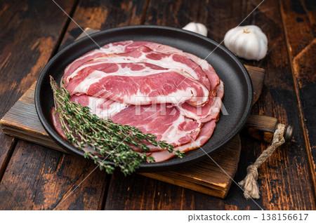 Cured pork French jambon cru arranged on a black plate with rosemary over wooden surface perfect for culinary photo stock. Cured pork French jambon cru arranged on a black plate with rosemary over wooden surface perfect for culinary photo stock. 138156617