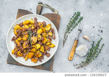 Skillet style beef hash, Golden roasted potatoes mixed with minced meat, top view on white plate. Skillet style beef hash, Golden roasted potatoes mixed with minced meat, top view on white plate. 138156627
