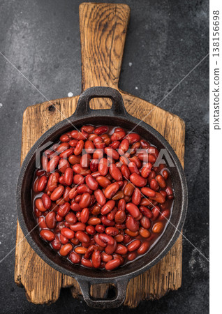 Top view of healthy vegan bean stew, garnished with fresh herbs. Moody style perfect for restaurant menus or recipe blogs. 138156698