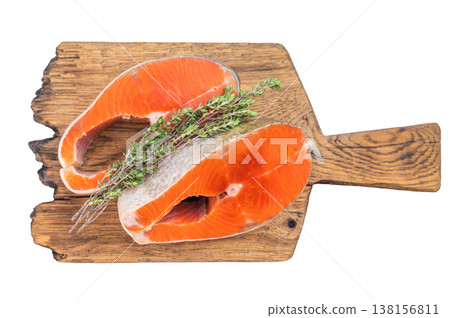 Closeup raw salmon steaks sockeye with bright orange flesh, thyme and lemon slices on isolated background 138156811