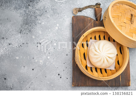 Nikuman steamed bun served in bamboo steamer, fluffy Asian dumpling with soft dough on light background with copy space 138156821