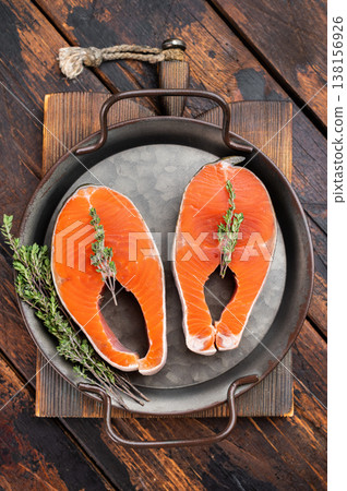 Raw coho salmon steaks also known pink salmon on metal pan over rustic wooden background with copy space Raw coho salmon steaks also known pink salmon on metal pan over rustic wooden background with copy space 138156926