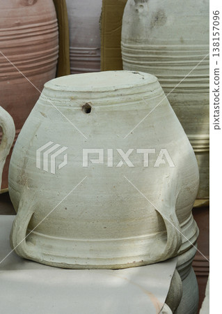 Upside down grey terracotta flower pot with handles 138157096