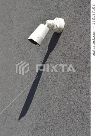 White security camera on a grey textured wall White security camera on a grey textured wall 138157108