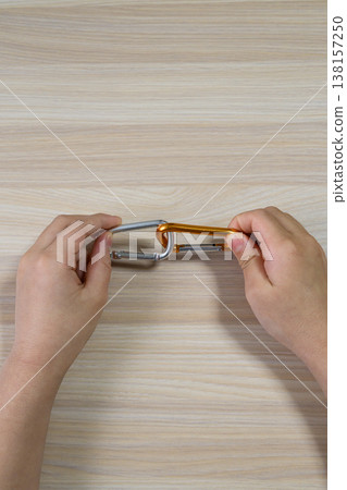 Connecting carabiner, hand, and copy space Connecting carabiner, hand, and copy space 138157250