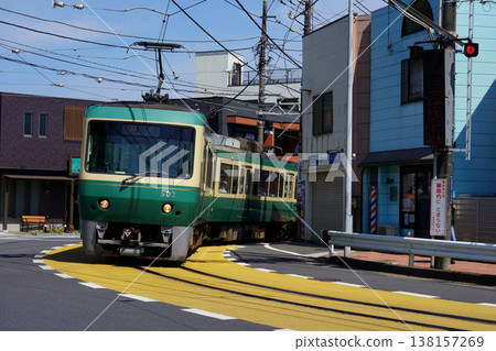 Under a clear sky, the Enoden 500 series train runs along the sharp curve at Koshigoe. Under a clear sky, the Enoden 500 series train runs along the sharp curve at Koshigoe. 138157269