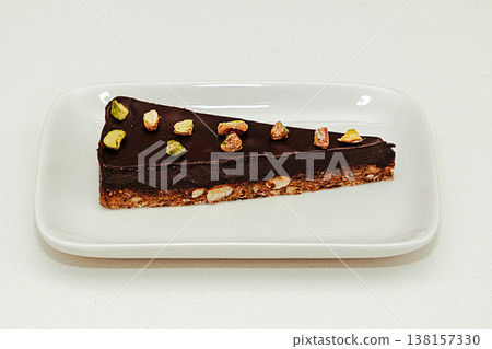 Raw chocolate cake on plate Raw chocolate cake on plate 138157330