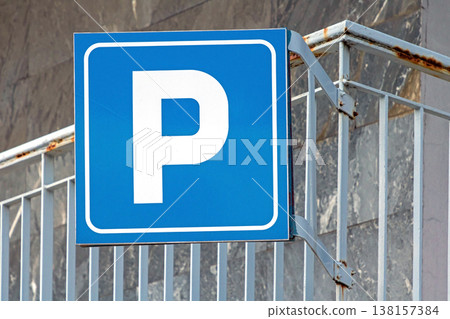 Parking sign on metal fence 138157384