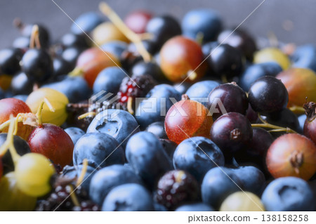 Blueberries, gooseberry and mulberries in dark ceramic bowl Blueberries, gooseberry and mulberries in dark ceramic bowl 138158258