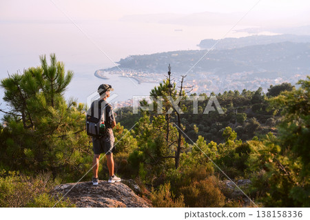 Summer landscape with tourist on the edge of the mountains Summer landscape with tourist on the edge of the mountains 138158336