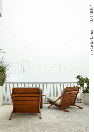Chairs placed on a balcony with a view of the sky Chairs placed on a balcony with a view of the sky 138158394