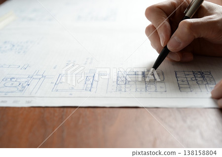 A man sketching a plan for the first-class architect design and drafting examination. A man sketching a plan for the first-class architect design and drafting examination. 138158804