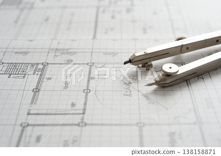 Close-up of an architect's hands working on a draft: creating architectural drawings using a compass. Close-up of an architect's hands working on a draft: creating architectural drawings using a compass. 138158871