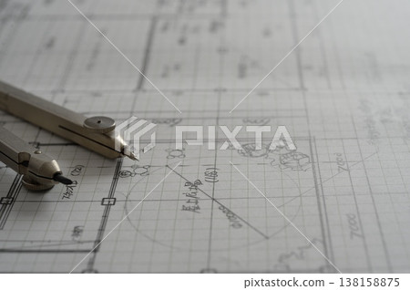 Close-up of an architect's hands working on a draft: creating architectural drawings using a compass. Close-up of an architect's hands working on a draft: creating architectural drawings using a compass. 138158875