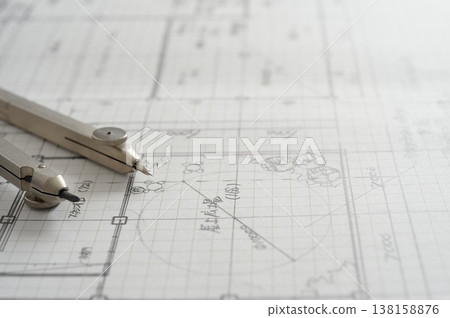 Close-up of an architect's hands working on a draft: creating architectural drawings using a compass. Close-up of an architect's hands working on a draft: creating architectural drawings using a compass. 138158876