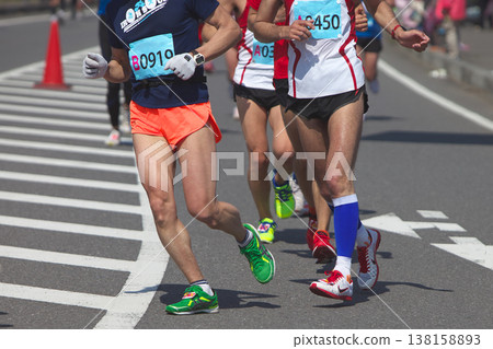 The dynamic movement of the feet and running shoes of amateur runners running smoothly in a marathon The dynamic movement of the feet and running shoes of amateur runners running smoothly in a marathon 138158893