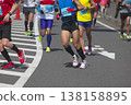 The dynamic movement of the feet and running shoes of amateur runners running smoothly in a marathon 138158895