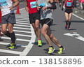 The dynamic movement of the feet and running shoes of amateur runners running smoothly in a marathon 138158896