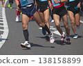 The dynamic movement of the feet and running shoes of amateur runners running smoothly in a marathon 138158899
