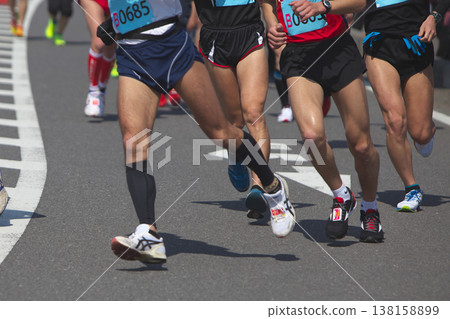The dynamic movement of the feet and running shoes of amateur runners running smoothly in a marathon The dynamic movement of the feet and running shoes of amateur runners running smoothly in a marathon 138158899