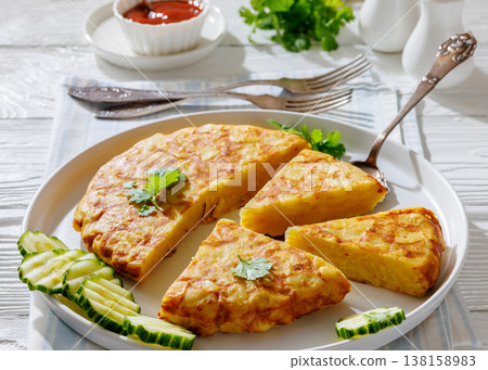 spanish potato omelette, tortilla on a plate spanish potato omelette, tortilla on a plate 138158983