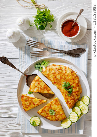spanish potato omelette, tortilla on a plate spanish potato omelette, tortilla on a plate 138158988