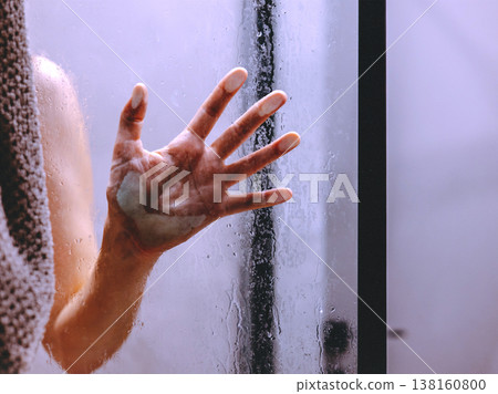 Female hand pressed against wet glass in a bathroom, symbolizing domestic abuse, violence. Mental health, toxic relationships, anxiety, seeking help. Female hand pressed against wet glass in a bathroom, symbolizing domestic abuse, violence. Mental health, toxic relationships, anxiety, seeking help. 138160800