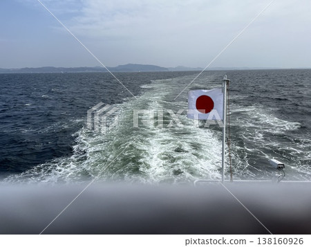 A view of Tokyo Bay from a ship, with the Japanese flag fluttering in the wind. A view of Tokyo Bay from a ship, with the Japanese flag fluttering in the wind. 138160926