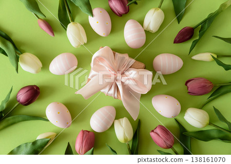 Easter Gift Box with Eggs and Spring Tulips on Green Background Easter Gift Box with Eggs and Spring Tulips on Green Background 138161070