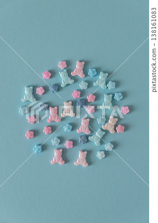 Easter Sugar Sprinkles in Shape of Teddy Bears and Flowers on Blue Background 138161083