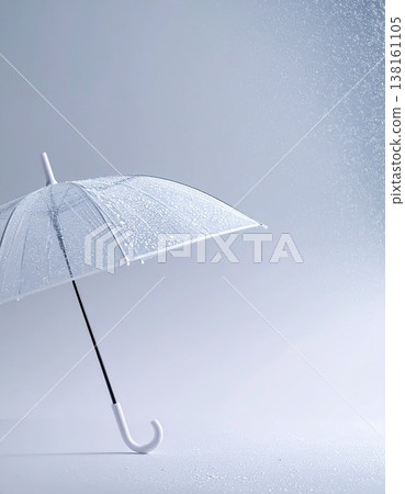 The handle of a transparent umbrella and the hint of rain; a quiet, minimalist urban background and ample white space. 138161105