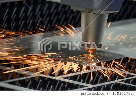 High-precision fiber laser cutting machine operation engraving and cutting complex patterns on a metal plate. High-precision fiber laser cutting machine operation engraving and cutting complex patterns on a metal plate. 138161792