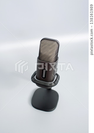 Sleek modern usb microphone on stand in minimalist setting Sleek modern usb microphone on stand in minimalist setting 138161989