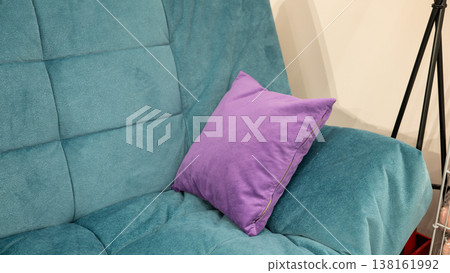 Purple pillow on blue sofa in living room interior setting 138161992