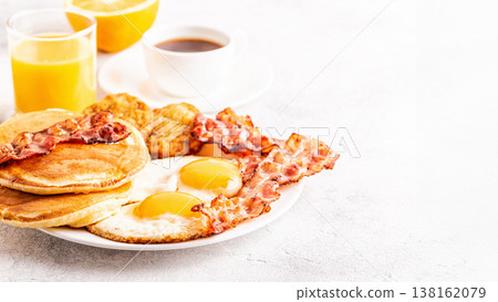 Healthy Full American Breakfast with Eggs Bacon Pancakes and Latkes. 138162079