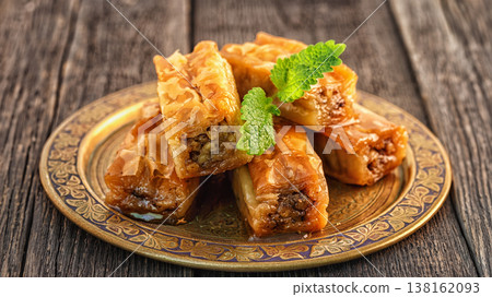 Traditional arabic dessert Baklava with honey and walnuts. 138162093
