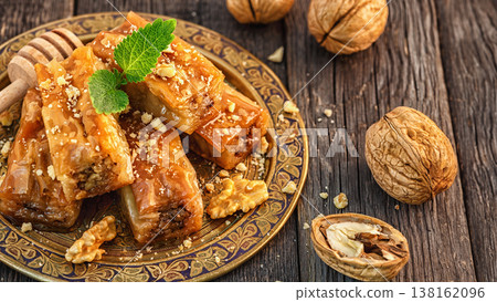 Traditional arabic dessert Baklava with honey and walnuts. 138162096