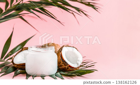 Coconut oil and coconuts on a bright pastel background. 138162126