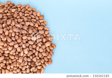 Organic Red beans on blue background. Top view Organic Red beans on blue background. Top view 138162185