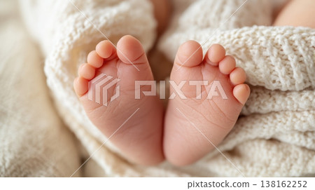 Twin newborn feet peeking from a cream knit blanket for newborn announcement background and baby care banner design Twin newborn feet peeking from a cream knit blanket for newborn announcement background and baby care banner design 138162252