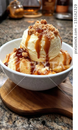 Peanut Butter Whiskey Ice cream scoops drizzled with caramel on kitchen counter Peanut Butter Whiskey Ice cream scoops drizzled with caramel on kitchen counter 138162329