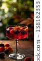 Wine coupe topped with fruit and flower in bokeh 138162353
