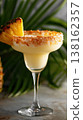 Pineapple cream margarita garnished on tropical backdrop 138162357
