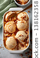 Multiple ice cream scoops in container with spoon and crumble 138162358