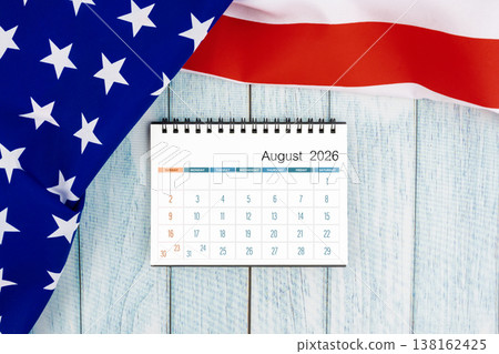 August 2026 monthly desk calendar with United States of America flag on wooden. August 2026 monthly desk calendar with United States of America flag on wooden. 138162425