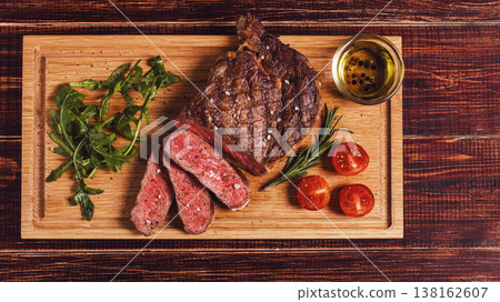 Ribeye steak with arugula and tomatoes. Ribeye steak with arugula and tomatoes. 138162607