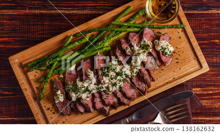 Steak with blue cheese sauce served with asparagus. Steak with blue cheese sauce served with asparagus. 138162632